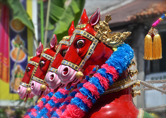 Row of red horse statues.