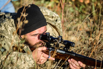 Fototapeta premium Hunting skills and weapon equipment. How turn hunting into hobby. Bearded man hunter. Army forces. Camouflage. Military uniform fashion. Man hunter with rifle gun. Boot camp. Army soldiers