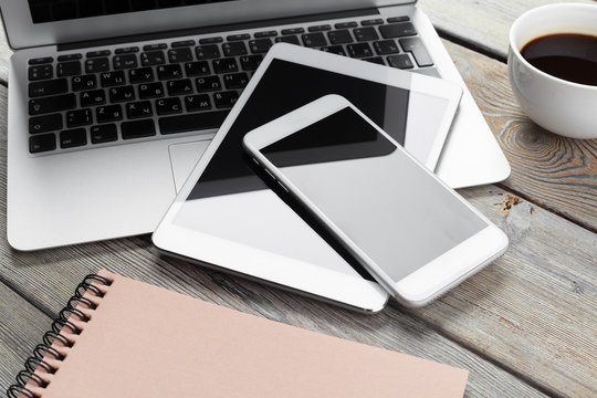 Open laptop with digital tablet and smartphone close up