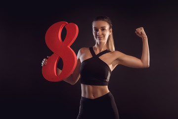 sporty blonde holds the figure eight in the hands
