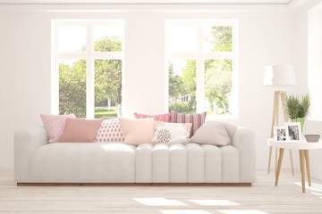 White stylish minimalist room with sofa and summer landscape in window. Scandinavian interior design. 3D illustration