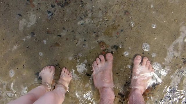 Father and Daughter Feet on Sandy Beach POV