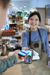 Male Customer Making Contactless Payment For Shopping Using Mobile Phone In Delicatessen