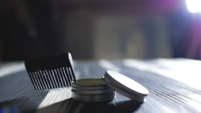 comb for beard and mustache lies near the wax.barber accessories