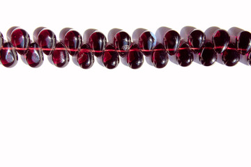 Cropped Shot Of Red Beads Over White Background. Abstract  Background Texture.