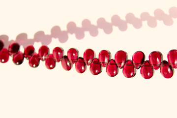 Cropped Shot Of Red Beads Over White Background. Abstract  Background Texture.