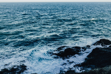 Naklejka na ściany i meble Waves in a turbulent and powerful sea, a windy day. Color blue.