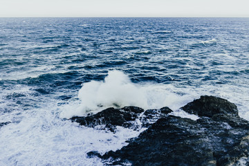 Waves in a turbulent and powerful sea, a windy day. Color blue.