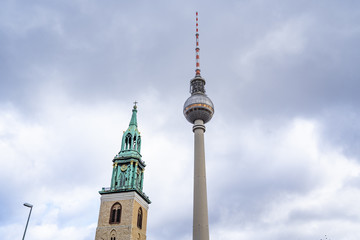 Obraz premium tv tower Berlin isolated on natural blue sky background, The TV Tower located on the Alexanderplatz in Berlin, Germany, tv tower with the st. Mary church in berlin