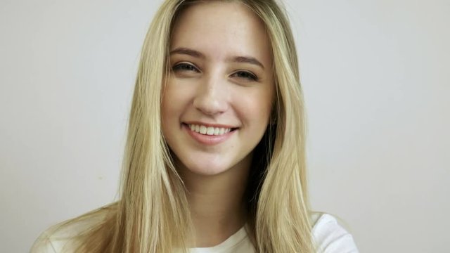 Portrait of beautiful young woman with natural makeup smiling, laughing, winking and looking at camera. 4K