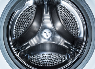 Clean drum of a modern washing machine close up.