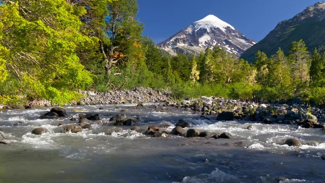 Lanin volcano in Lanin national park. Landscape with volcano, mountain river and green trees. Argentina, Patagonia, Lake district