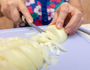Woman cuts a bow with a knife