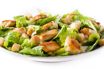 Caesar salad with lettuce,chicken and croutons isolated on white background. Close up