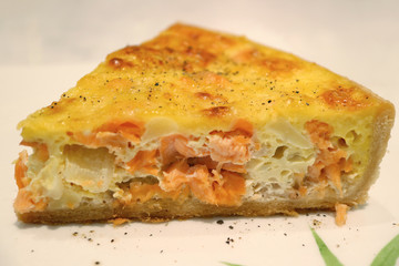 Front View of Delicious Salmon and Onion Quiche Served on White Plate