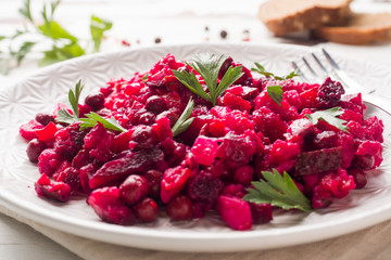 Fresh homemade Beetroot salad Vinaigrette in a white bowl. Traditional Russian food.