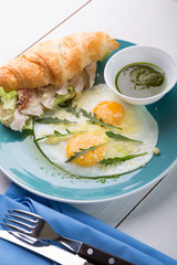 Fried eggs with croissant served for breakfast
