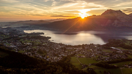 great sunrise behind a huge mountain in Austria with a amazing lake in the foreground, amazing sunrise in the nature of the Austrian alps, drone wildlife photography, fall season in austria