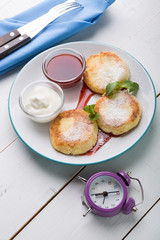 Fritters served with jam and cream for breakfast