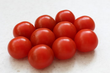 Red big tomatoes stack isolated on table.