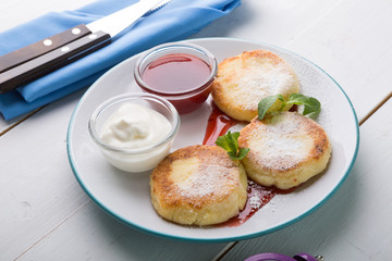 Fritters served with jam and cream for breakfast