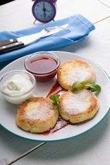 Fritters served with jam and cream for breakfast