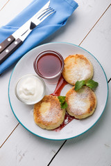 Fritters served with jam and cream for breakfast