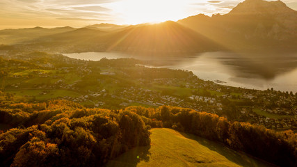 great sunrise behind a huge mountain in Austria with a amazing lake in the foreground, amazing...