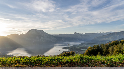 great sunrise behind a huge mountain in Austria with a amazing lake in the foreground, amazing...