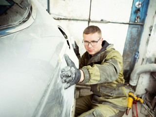 Cute guy in black glasses with black gloves displays the shape of the hood for the subsequent...