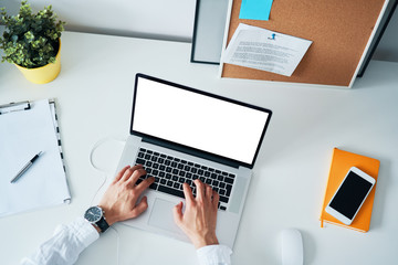 Laptop mockup. Close-up of man typing on laptop.