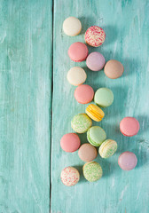 colorful macaroons on turquoise surface