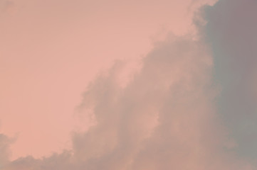 Coral colored sky background with clouds. Abstract image.