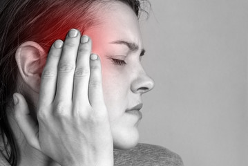 Fototapeta premium Headache in the temples. Sick girl suffering from head migraine, feeling pressure and stress.