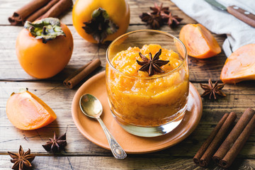 Persimmon fruit smoothie with cinnamon and anise stars, wooden table