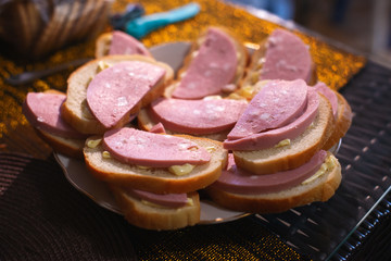 Sandwiches with boiled sausage on a plate