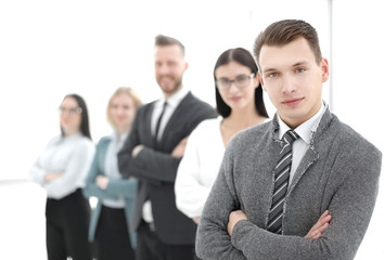 young businessman standing in front of his business team