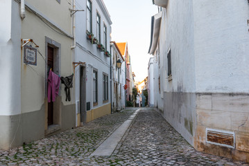 Fototapeta na wymiar Cobblestone alley in traditional old neighbourhood in Cascais Portugal