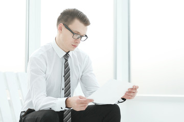 businessman reading a business document sitting in the office