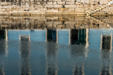 Water reflection of marine administrative building quayside in Lisbon Portugal