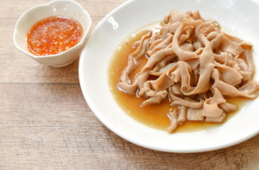 stewed duck intestine in brown soy soup on plate dipping spicy sauce