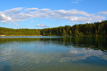 Obraz na płótnie Canvas Evening on the lake in a pine forest. Blue lakes in Chernihiv region, Ukraine