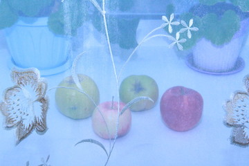 apples behind a transparent cloth