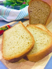 Jewish bread cut on pieces, slices on brown wooden background and fabric napkin 