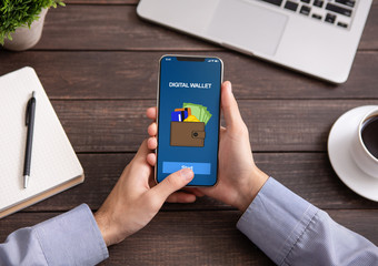 Man holding smartphone with digital wallet application