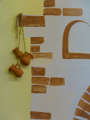 Styled old Russian interior, earthenware jugs hanging on the ropes on the wall