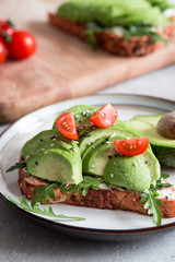 healthy breakfast with avocado and Delicious wholewheat toast. sliced avocado on toast bread with spices. Mexican cuisine