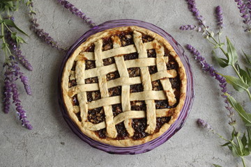 pie on a plate with purple flovers