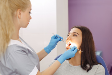 Dentist examining a patient's teeth in the dentist office