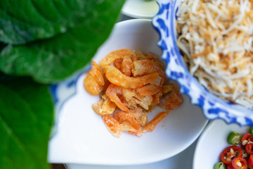 close up dried shrim on white spoon for miang kum ingredient